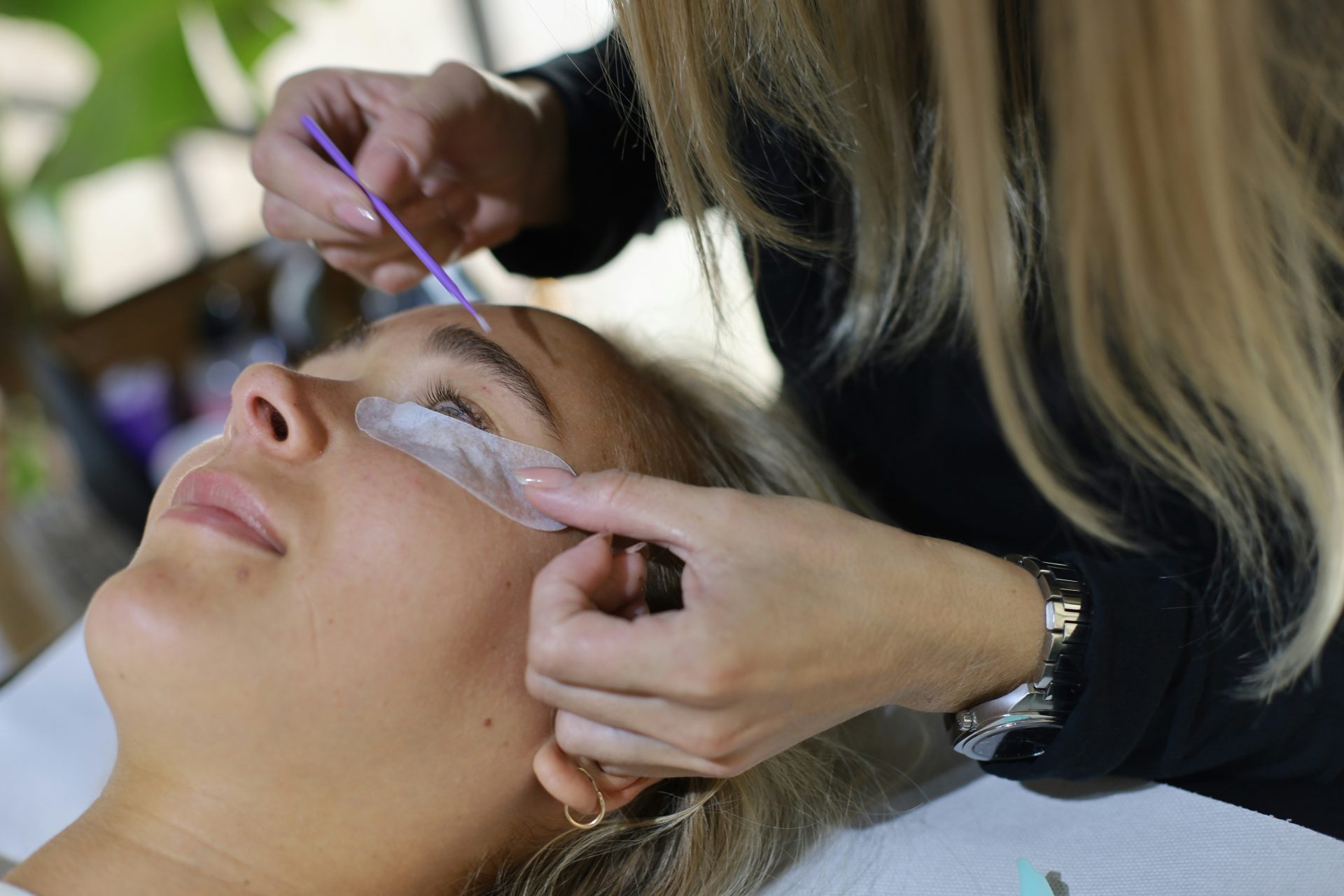 A woman getting her hair cut by a hair stylist